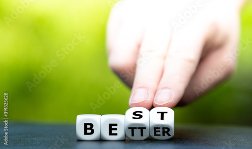 Hand turns dice and changes the word "better" to "best".