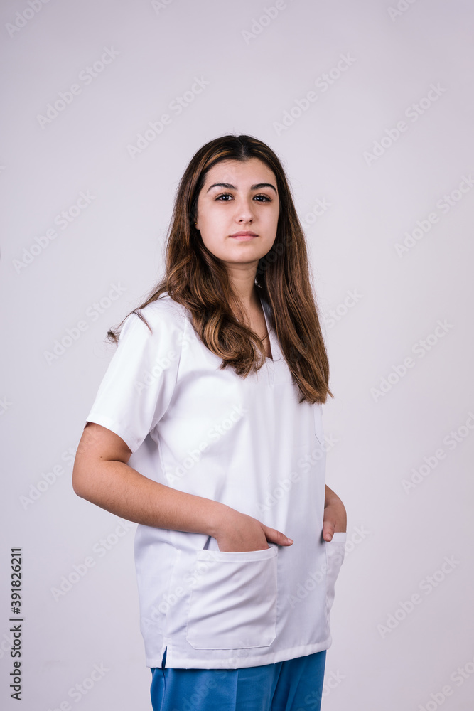 female dentist staring into the camera. Her hands are in the pockets of her white coat female dentist staring into the camera. Her hands are in the pockets of her white coat