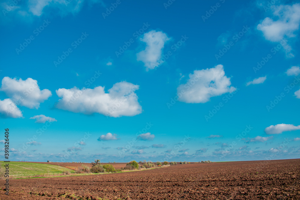 Rural landscape. Fields prepared for growing crops. Landscape with clouds and sky. Rural landscape. Fields prepared for growing crops. Landscape with clouds and sky.
