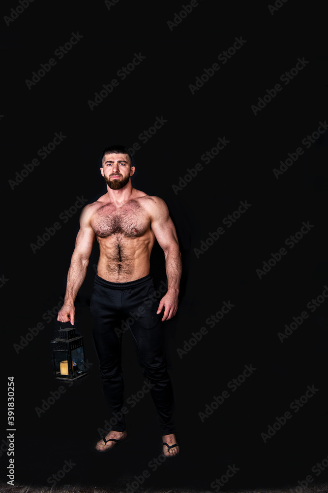 Naklejka premium handsome physically well-developed man with a mock planet earth in his hands