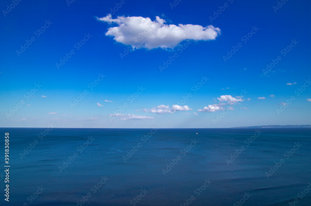 Beautiful natural sea landscape in sunny day. Beauty world, blue sky with white clouds. Deep blue backdrop, background wallpaper