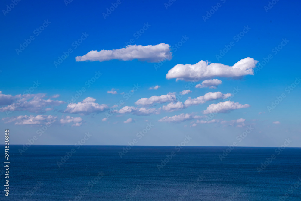 Beautiful natural sea landscape in sunny day. Beauty world, blue sky with white clouds. Deep blue backdrop, background wallpaper Beautiful natural sea landscape in sunny day. Beauty world, blue sky with white clouds. Deep blue backdrop, background wallpaper