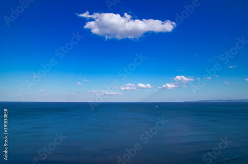 Beautiful natural sea landscape in sunny day. Beauty world, blue sky with white clouds. Deep blue backdrop, background wallpaper