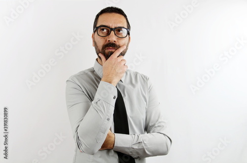 A pensive businessman with beard and glasses on a white background. Bisness concept