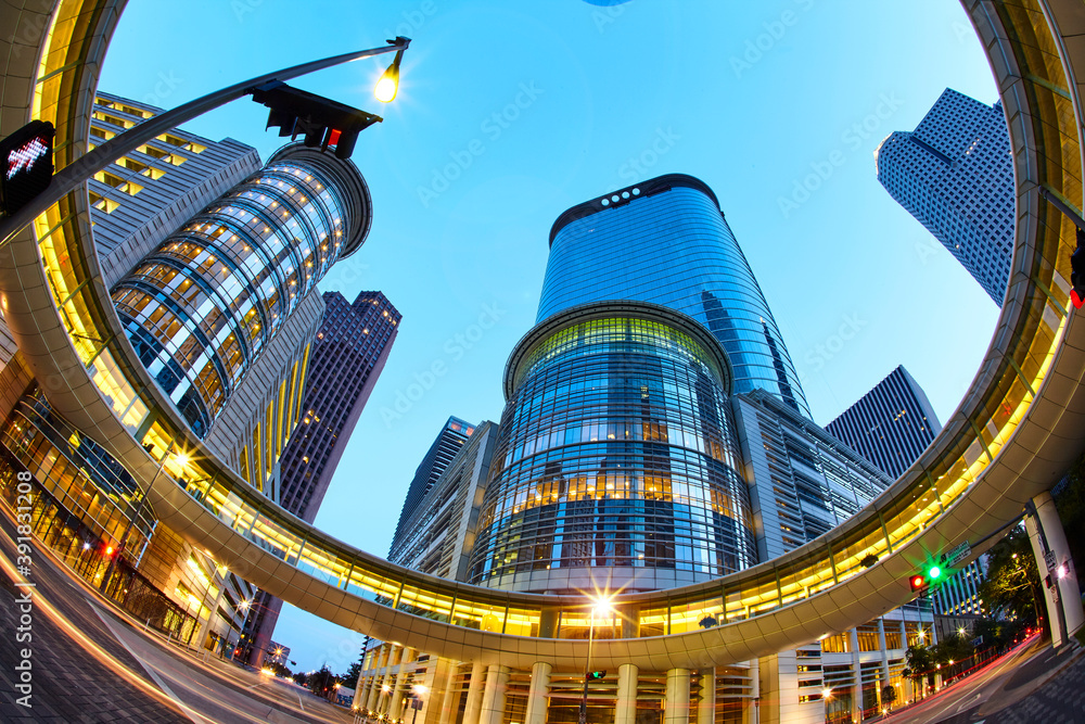Postmodern skyscrapers at 1400 Smith Street illuminated at dusk in Downtown Houston