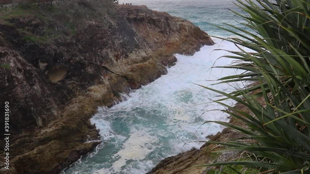 Slow Motion Looking Down Into A Ocean Gorge With Rough Blue And White Wash Water Swirling Between Two Tall Cliffs Slow Motion Looking Down Into A Ocean Gorge With Rough Blue And White Wash Water Swirling Between Two Tall Cliffs