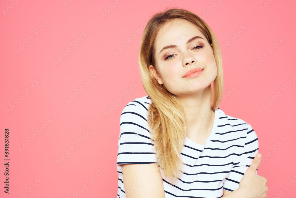 Woman in striped t-shirt emotions studio cropped view lifestyle pink isolated background Woman in striped t-shirt emotions studio cropped view lifestyle pink isolated background