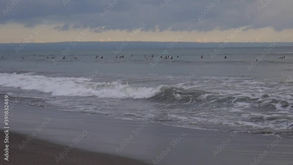 surfers float in the ocean waiting for a wave surfers float in the ocean waiting for a wave