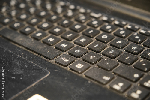 Dirty, dusty keyboard. Uncleaned, dust, dirt accumulated between the keys laptop keyboard. 