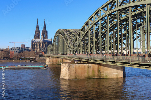 The Hohenzollern bridge over Rhine river on a sunny day. The Cologne Cathedral (Kolner Dom) in the city of Cologne, Germany. It is the largest Gothic church in northern Europe. © An Instant of Time