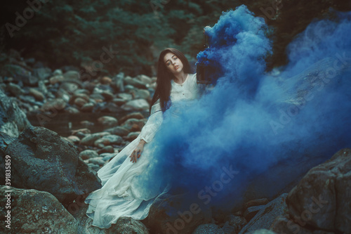 Beautiful woman among blue smoke © captblack76