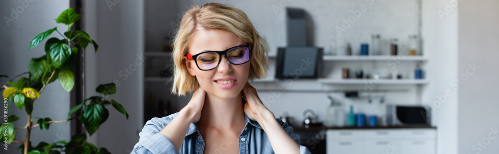 young blonde woman in eyeglasses kneading neck, horizontal banner young blonde woman in eyeglasses kneading neck, horizontal banner