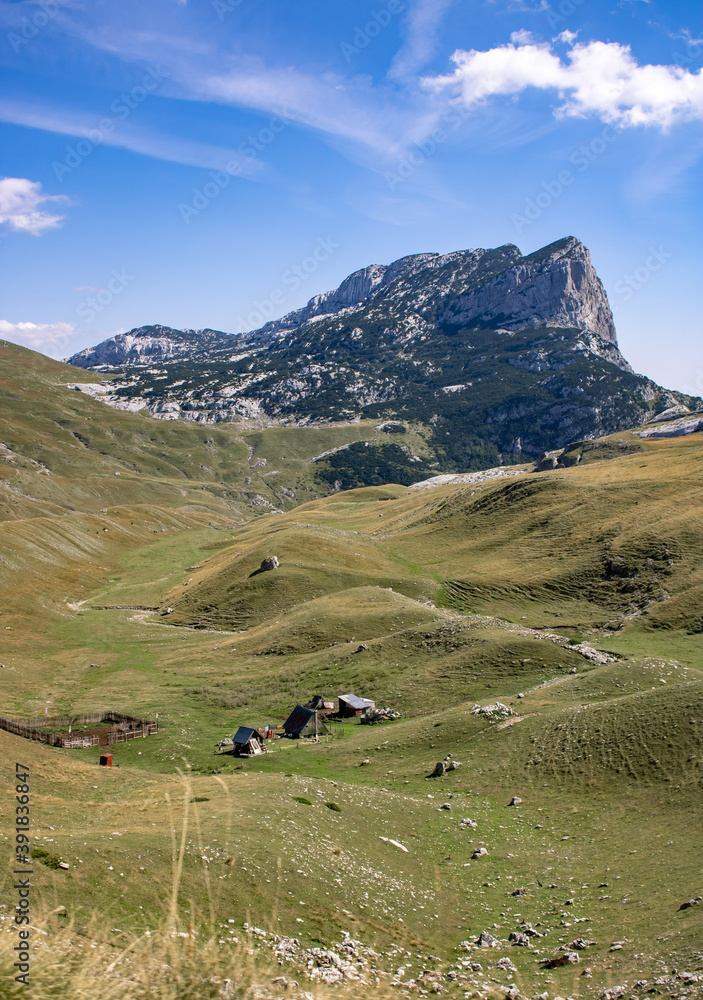 Fantastic mountains of Montenegro. A lonely house among the mountains. Picturesque mountain landscape of Durmitor National Park, Montenegro, Europe, Balkans, Dinaric Alps, UNESCO World Heritage Site.