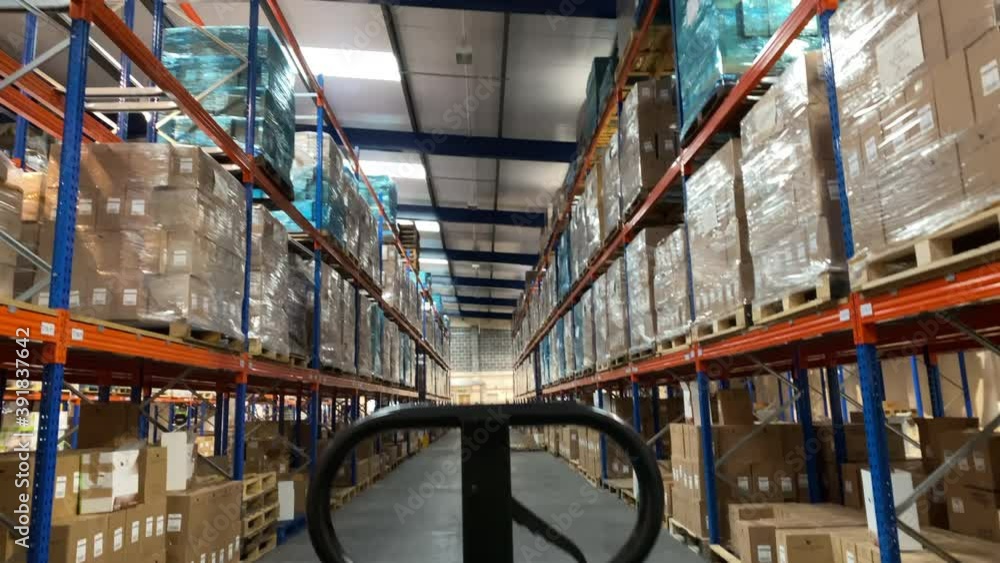 rising shot of a warehouse interior from behind a pallet truck rising shot of a warehouse interior from behind a pallet truck