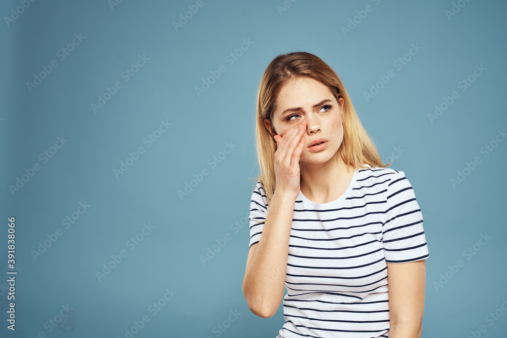 Emotional woman striped t-shirt lifestyle cropped blue background Emotional woman striped t-shirt lifestyle cropped blue background