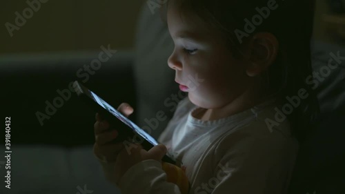 Preschool child using phone at night. Kids insomnia. Toddler using gadgets 