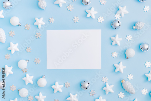 Mockup white greeting card with christmas decorationon a blue background photo