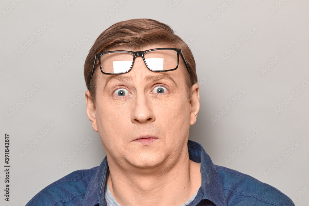 Portrait of surprised impressed man with glasses raised on forehead Portrait of surprised impressed man with glasses raised on forehead
