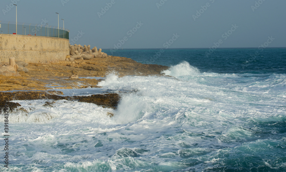 Stormy autumn day in Marsaskala, Malta.  Big waves, sunny day, dangerous sea. Winter in Malta
