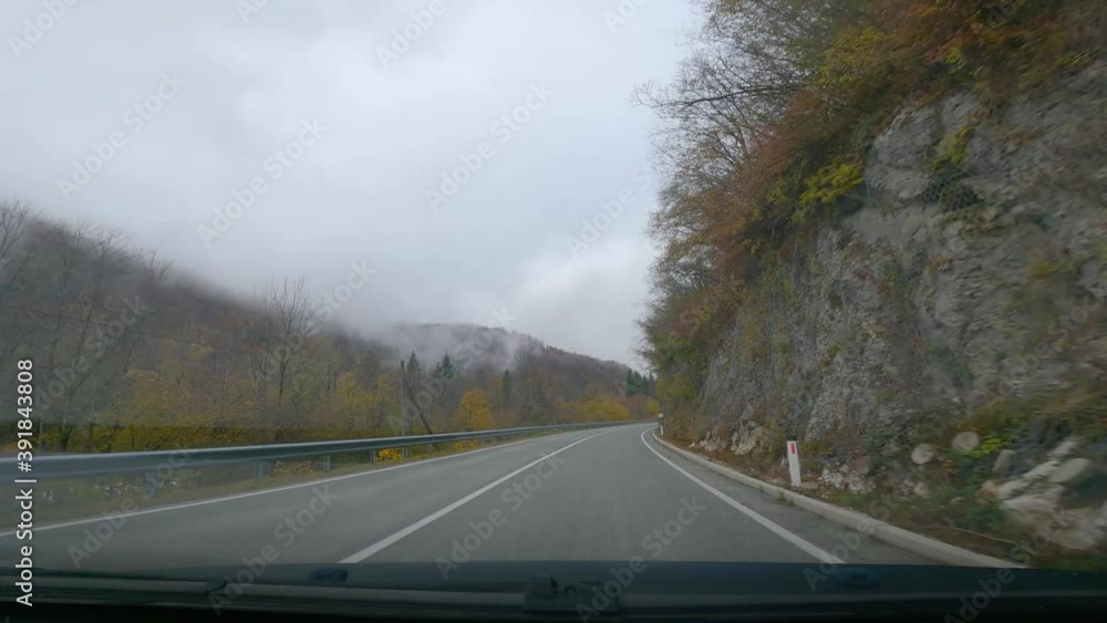POV point of view dashcam dash camera driving on paved countryside road, Slovenia. Colorful forest in autumn season and Alps mountains. Wide angle, forward dolly moving, real time POV point of view dashcam dash camera driving on paved countryside road, Slovenia. Colorful forest in autumn season and Alps mountains. Wide angle, forward dolly moving, real time