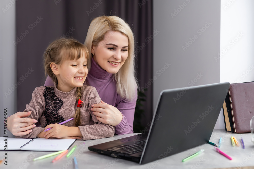 Woman with girl doing homework on laptop Woman with girl doing homework on laptop