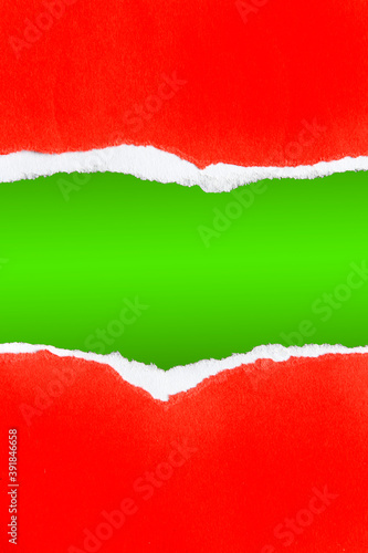 Gap in ripped red paper on green. Copy space. Christmas background.