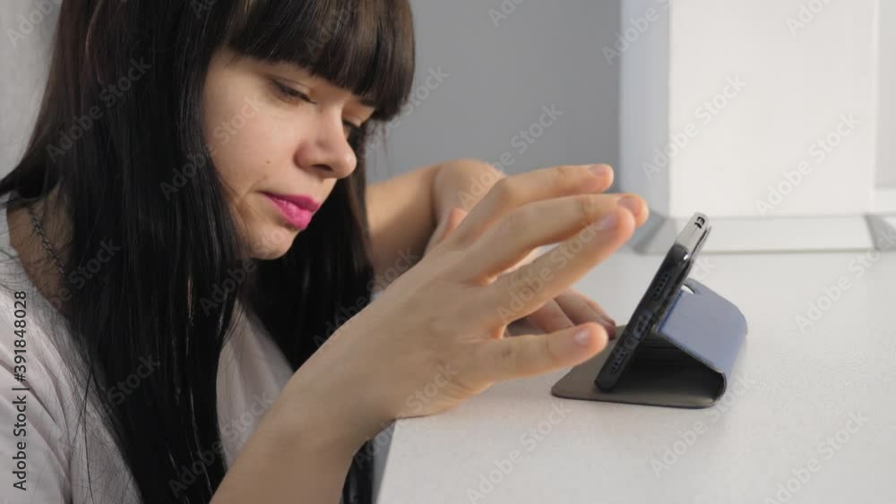 girl lifestyle surfs the page online on a smartphone. girl watching online shopping at a shopping on a digital phone store girl lifestyle surfs the page online on a smartphone. girl watching online shopping at a shopping on a digital phone store