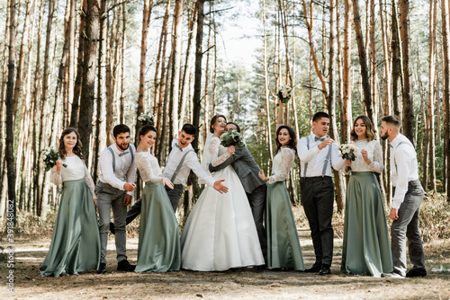 Beautiful wedding couple with bridesmaids and grooms,happy newlyweds hugging with their friends on their wedding day,european happy couple celebrate their marriage with 