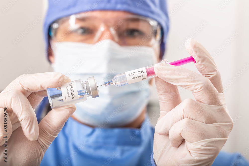 A medical worker putting SARS-CoV-2 vaccine against the coronavirus into an injection A medical worker putting SARS-CoV-2 vaccine against the coronavirus into an injection