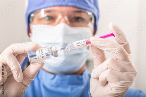 A medical worker putting SARS-CoV-2 vaccine against the coronavirus into an injection