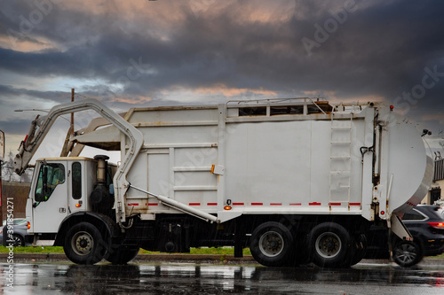 Garbage truck driving on the highway in the city