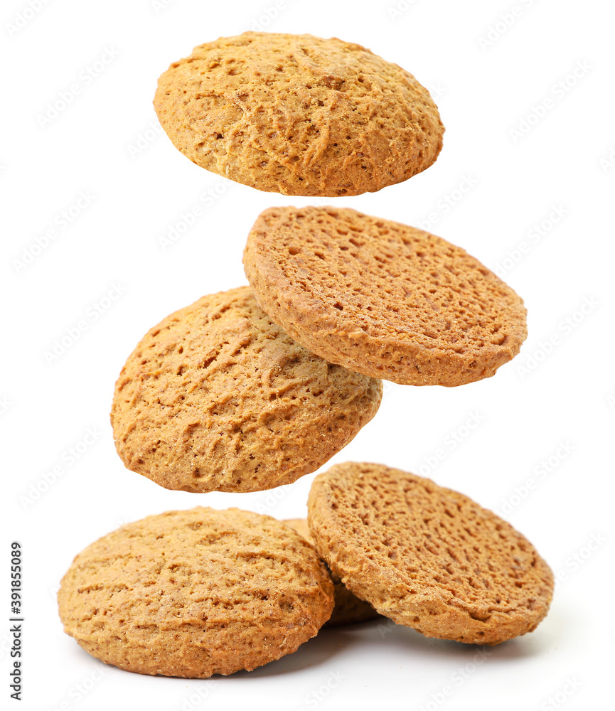 Oatmeal cookies flies and falls on a pile on a white background, levitating cookies. Isolated Oatmeal cookies flies and falls on a pile on a white background, levitating cookies. Isolated