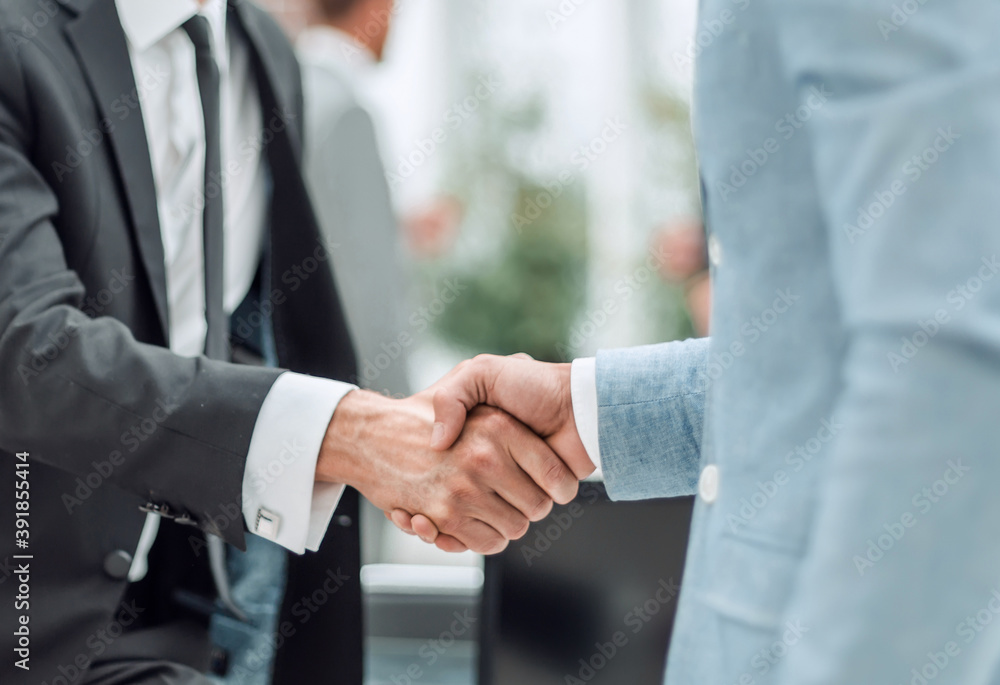 close up. business handshake on the background of the office. close up. business handshake on the background of the office.
