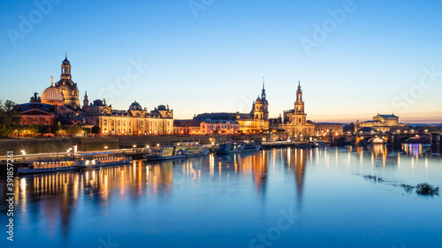 Panorama of the famous historical old town of Dresden located in Saxony and the river Elbe during during blue hour. Famous sights of the city Dresden illuminated in the evening. © corofisch