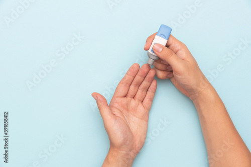 Papier peint Man using lancet for diabetes