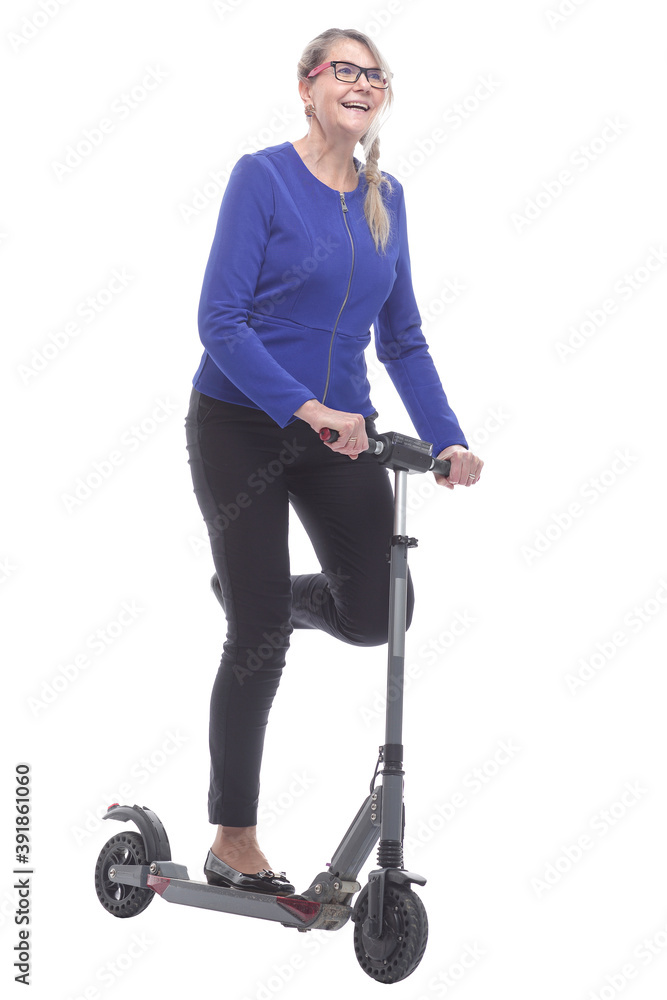 in full growth. positive mature woman with electric scooter. in full growth. positive mature woman with electric scooter.