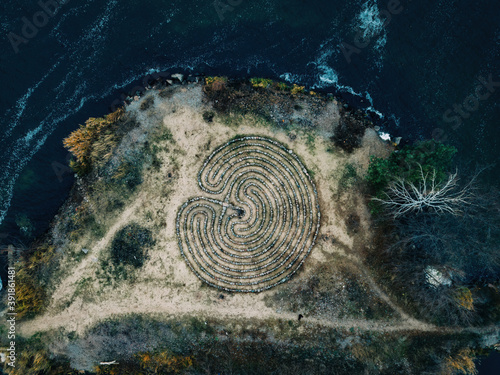 Spiral labyrinth made of stones on the cost, top view from drone photo