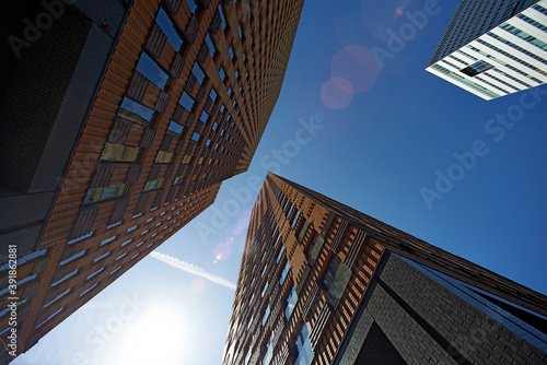 Photography Looking up at high rise skyscrapers office towers in bright sunshine