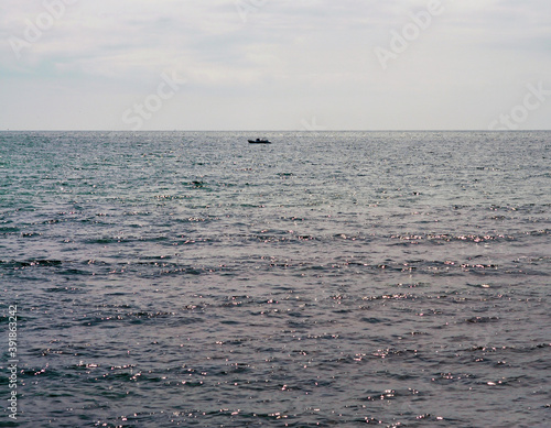 Seascape with a lonely boat on the horizon. Primorsky Krai, Russia.