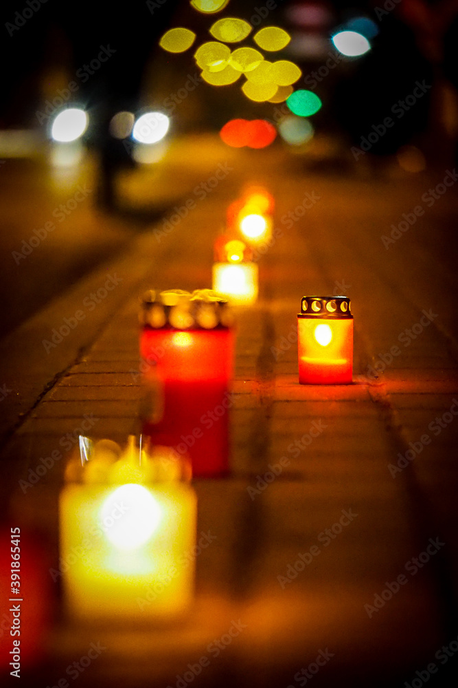 Candles on the sidewalk in memory of victims of a tragic accident, mourning, memory. Selective focus Candles on the sidewalk in memory of victims of a tragic accident, mourning, memory. Selective focus