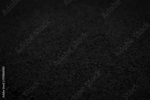 Abstract black background with sandpaper texture. Dark blurred mysterious image for elegant style decor, banner backdrop