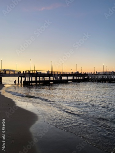 sunset on the baltic sea coast and a pier
