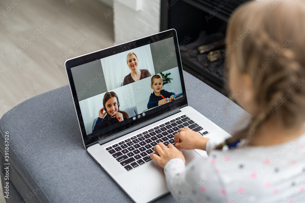 A Girl Video Conferencing With Happy Female Teacher On Laptop A Girl Video Conferencing With Happy Female Teacher On Laptop