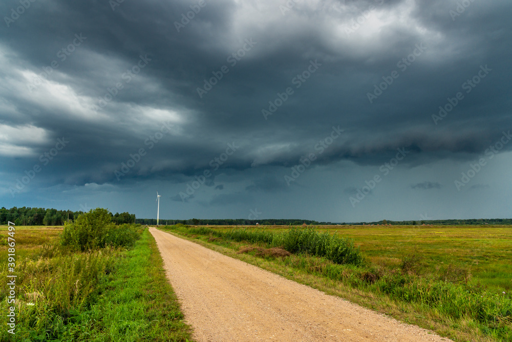 Dramatic view of a shelf cloud over a field, horizontal cloud formation, panorama view. Dramatic view of a shelf cloud over a field, horizontal cloud formation, panorama view.