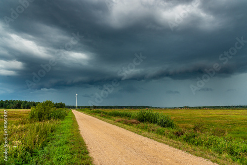 Dramatic view of a shelf cloud over a field  horizontal cloud formation  panorama view.