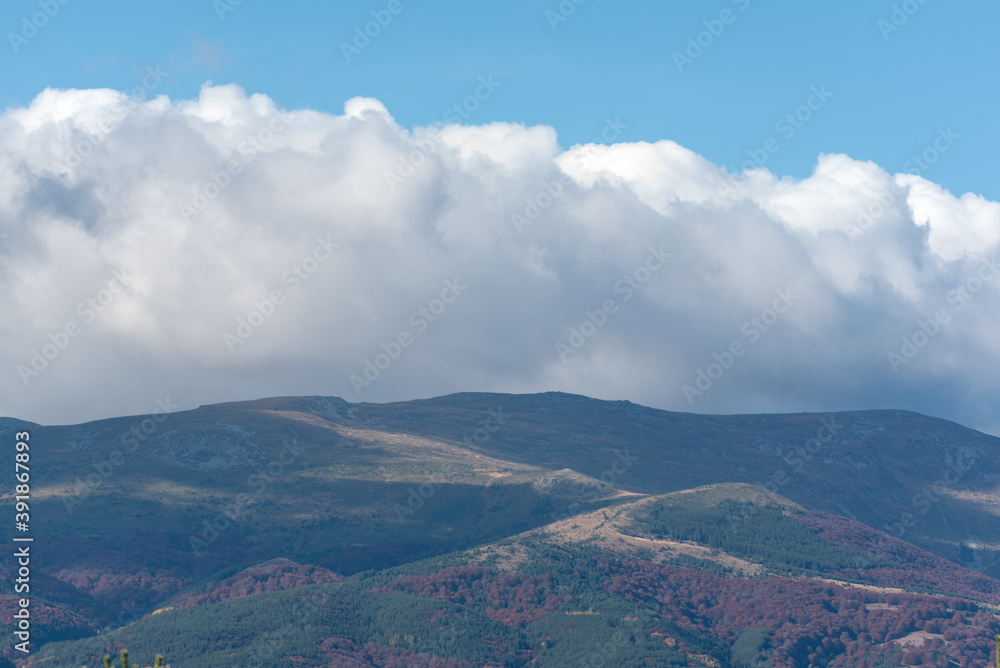 Autumn misty landscape with couldy moody sky rural mountain woodland bulgaria