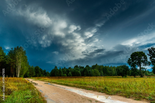 Dramatic view of a cloud over a field, horizontal cloud formation, panorama view.