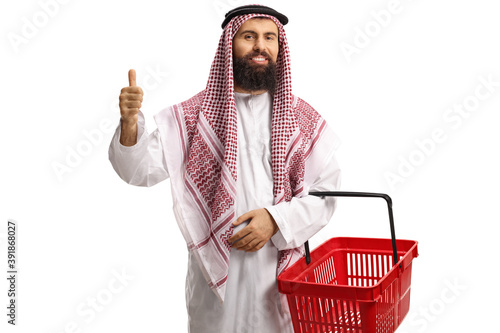 Saudi arab man in a thobe with a shopping basket gesturing thumbs up photo