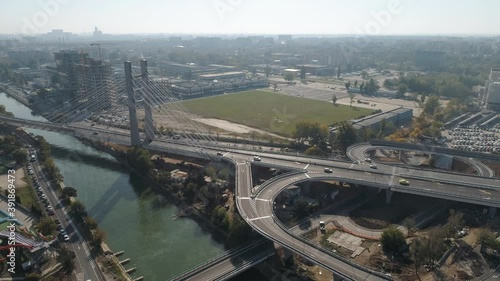 Aerial footage of a suspended bridge in Bucharest on a sunny day photo