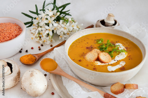 Orange soup in a bowl, pumpkin, carrot or coral lentils